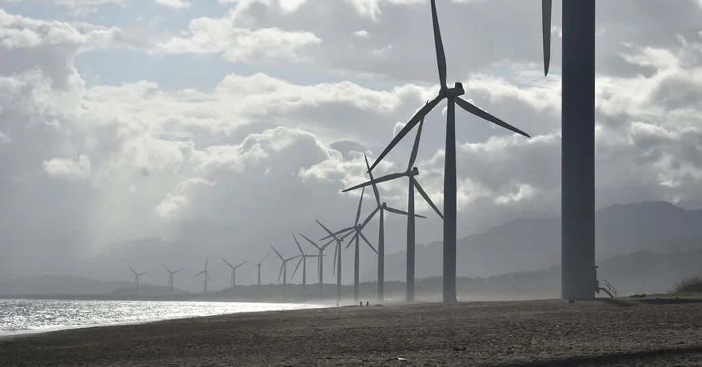 Wind turbines generating electricity near a residential neighborhood